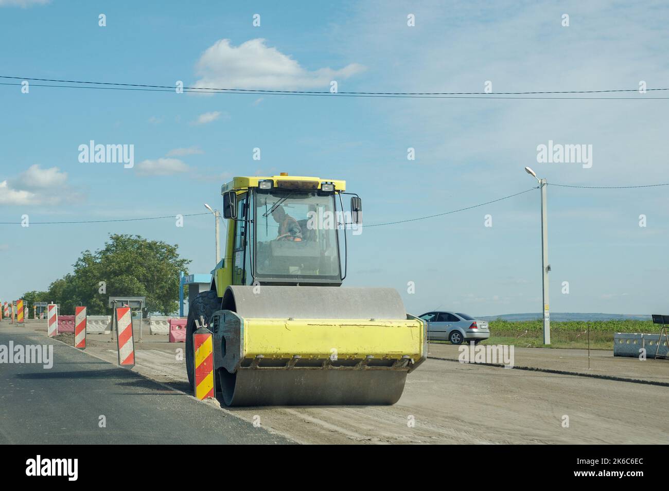 Working Car Compactor The road rollers working on the new road construction, compactor ...