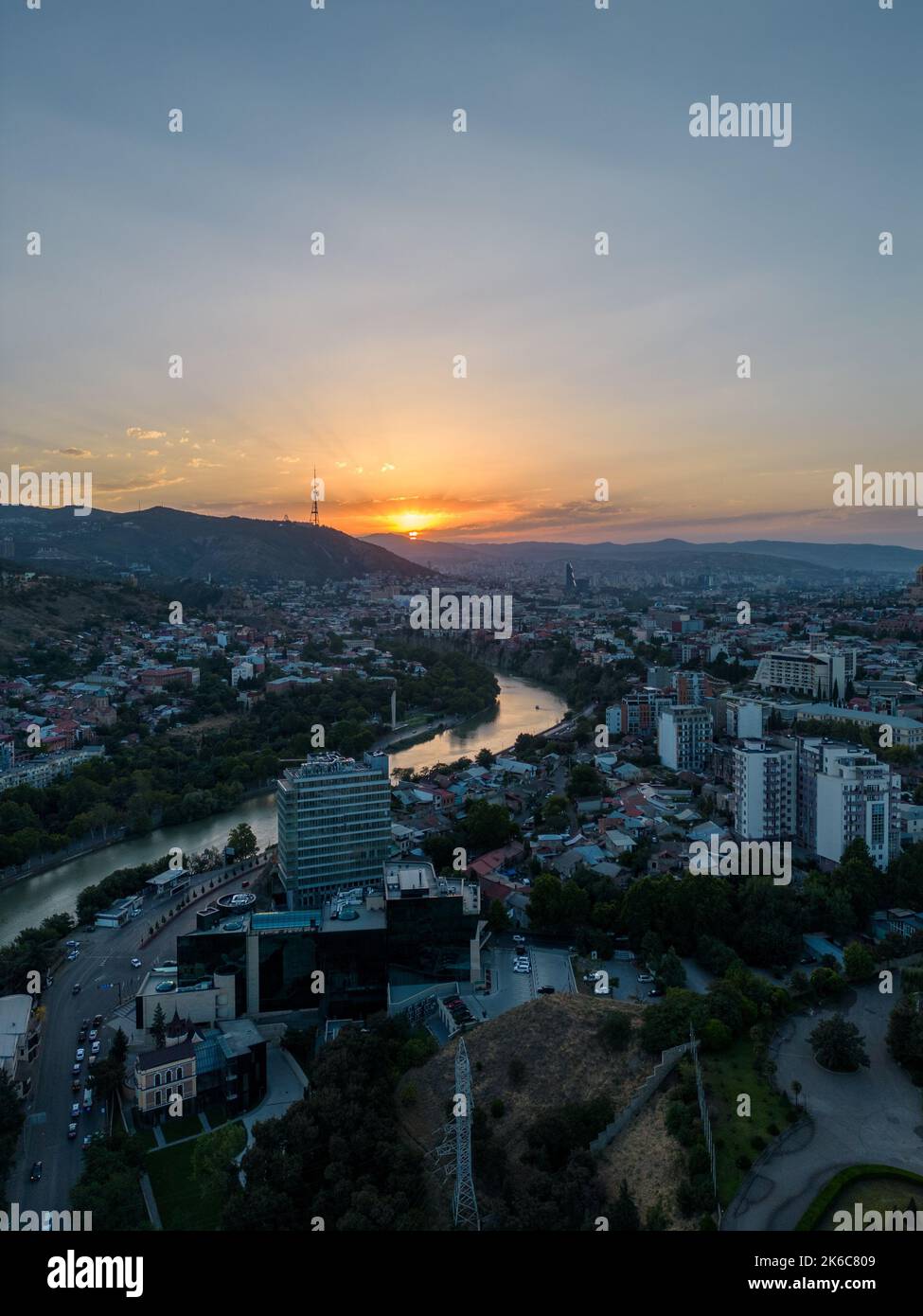 An aerial view of a city and landscape during sunset Stock Photo - Alamy
