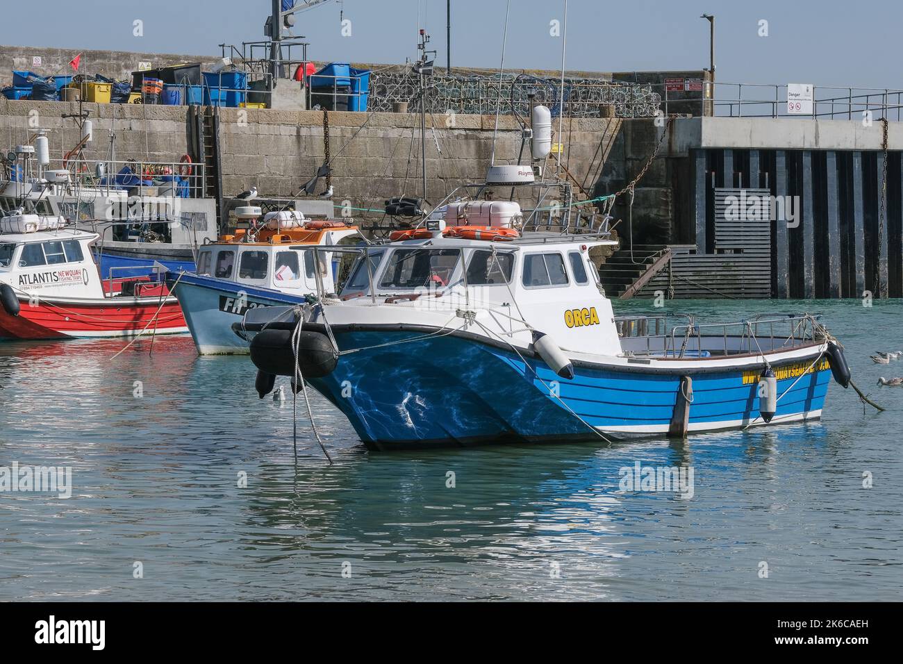 Various charter and fishing boats moored in Newquay Harbour Harbor in Cornwall in England in the UK. Stock Photo