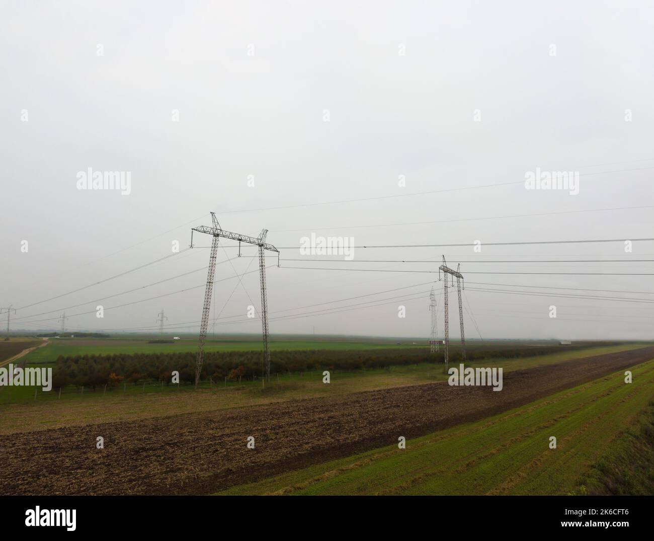 Electric poles out in the field. Stock Photo