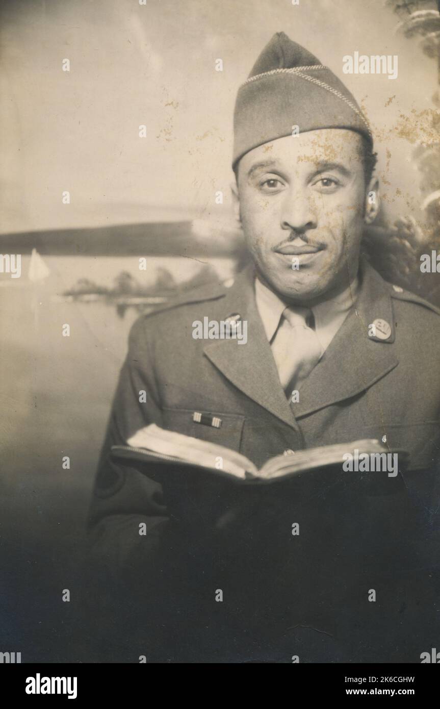 Man in USA Army Uniform Holding Book Stock Photo