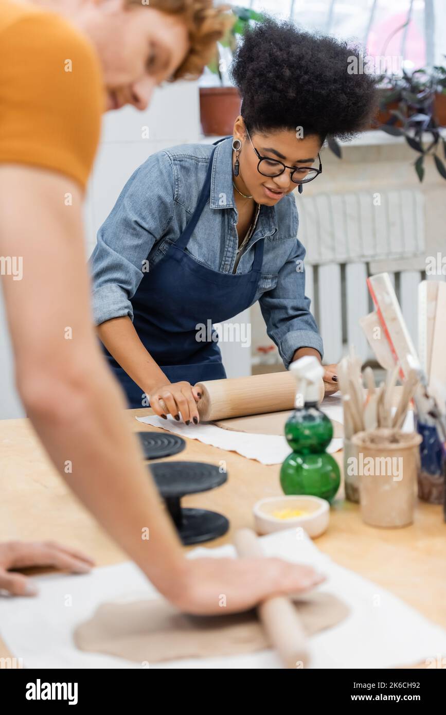 Ceramic Workshop. Clay rolling pin. Work table. Stock Photo by  solerfotostock