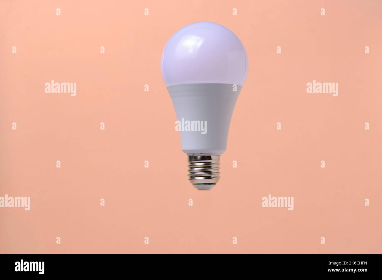 LED eco light bulb on beige background Stock Photo