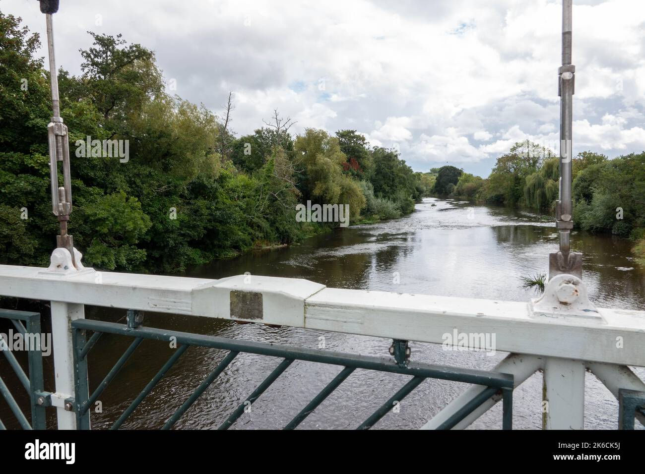 view of the River Exe from Trews Weir Suspension Bridge across the Exeter Ship Canal Stock Photo