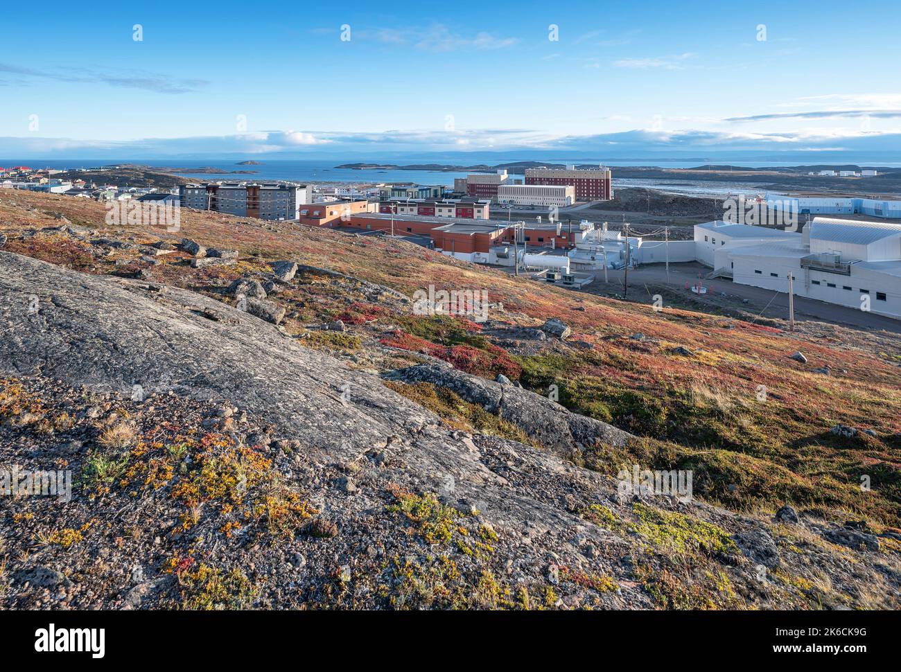 Overview of the city of Iqaluit with the Arctic Ocean harbor in the distance Stock Photo