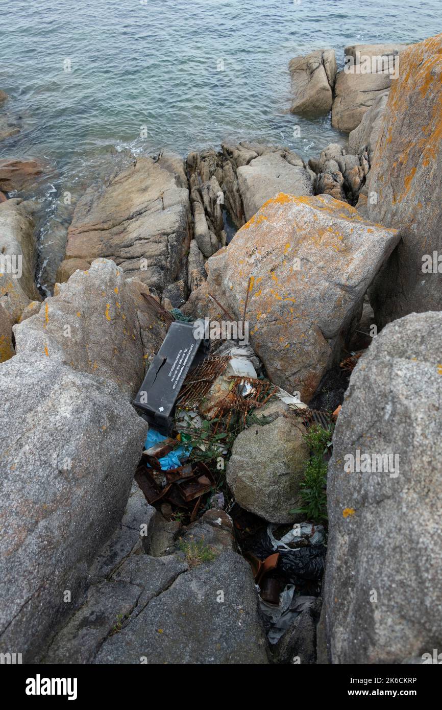 Ocean pollution and fishing garbage washed up on the rocks at Bulloch Harbour Dalkey near Dublin Ireland Stock Photo