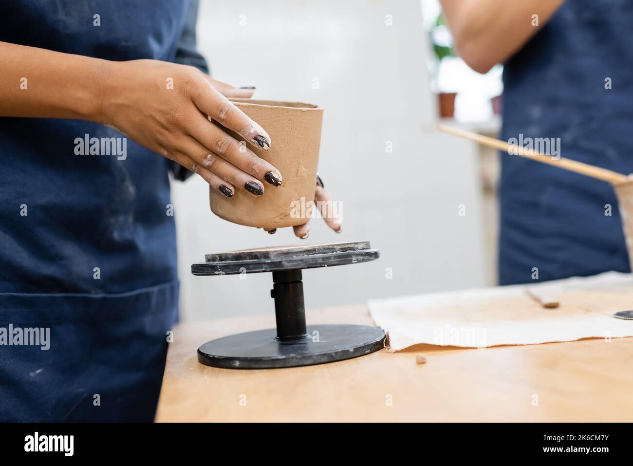 Cropped view of african american woman holding clay product in pottery studio,stock image Stock Photo