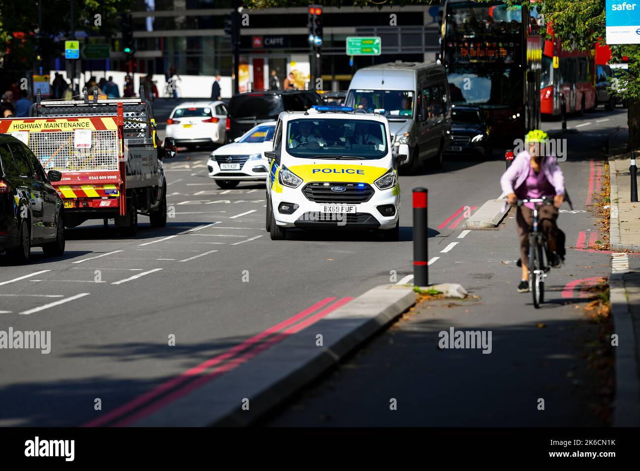 Stock image of a police van on an emergency call driving through