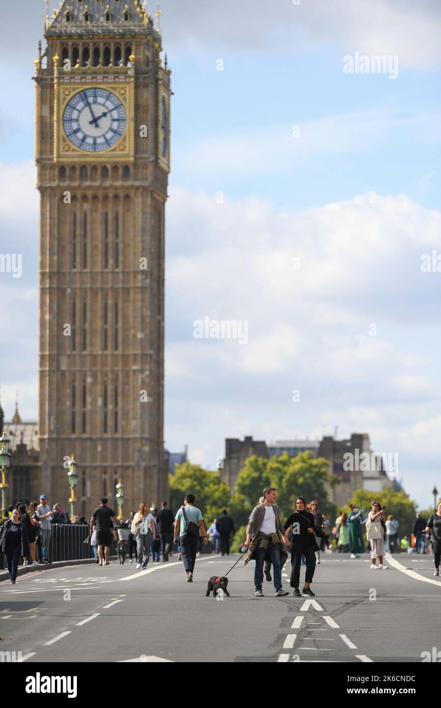 Members of the public take the chance to walk on the road at Westminster Bridge after the bridge is shut to traffic for Queens lying in state. Stock Photo