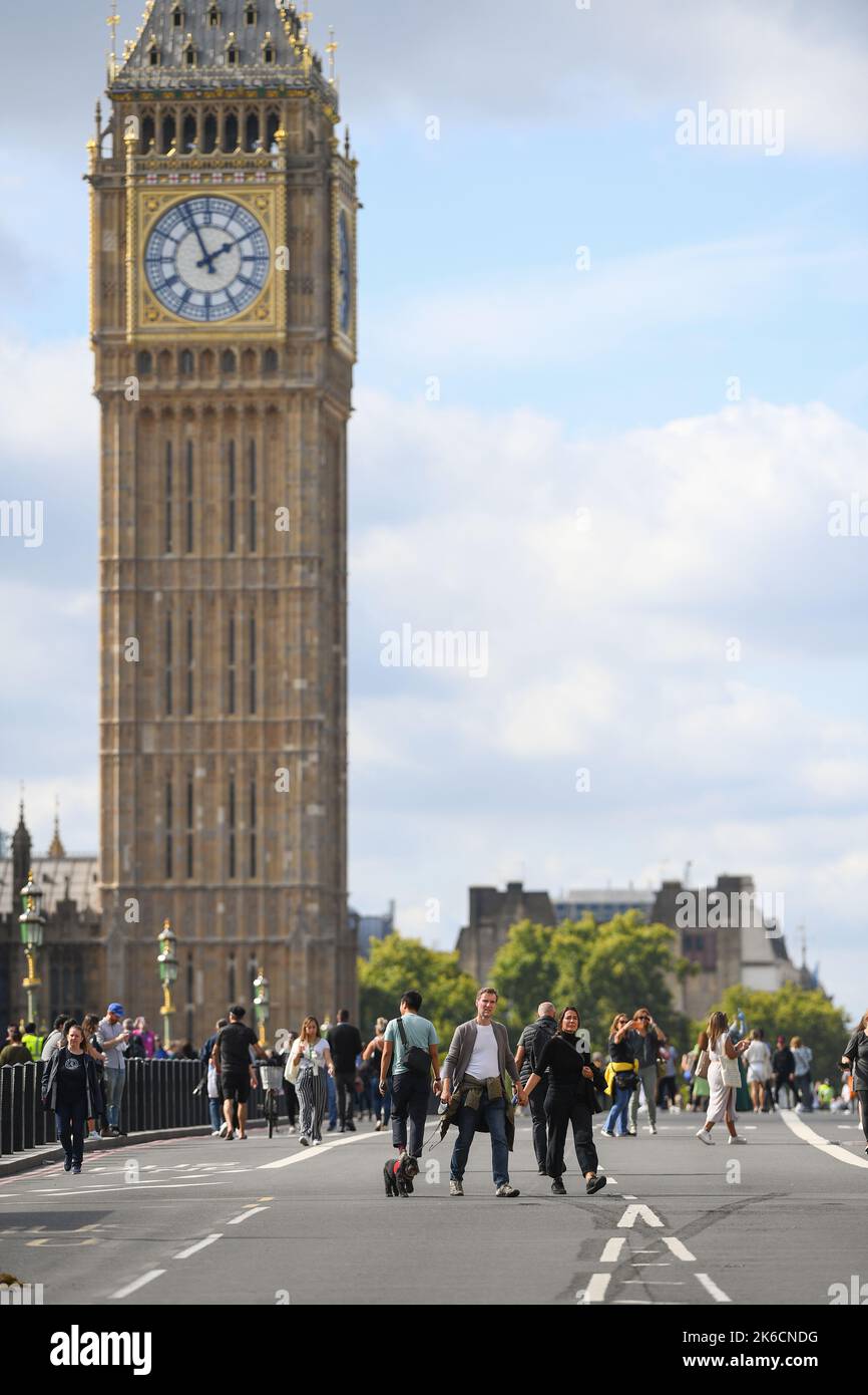 Members of the public take the chance to walk on the road at Westminster Bridge after the bridge is shut to traffic for Queens lying in state. Stock Photo