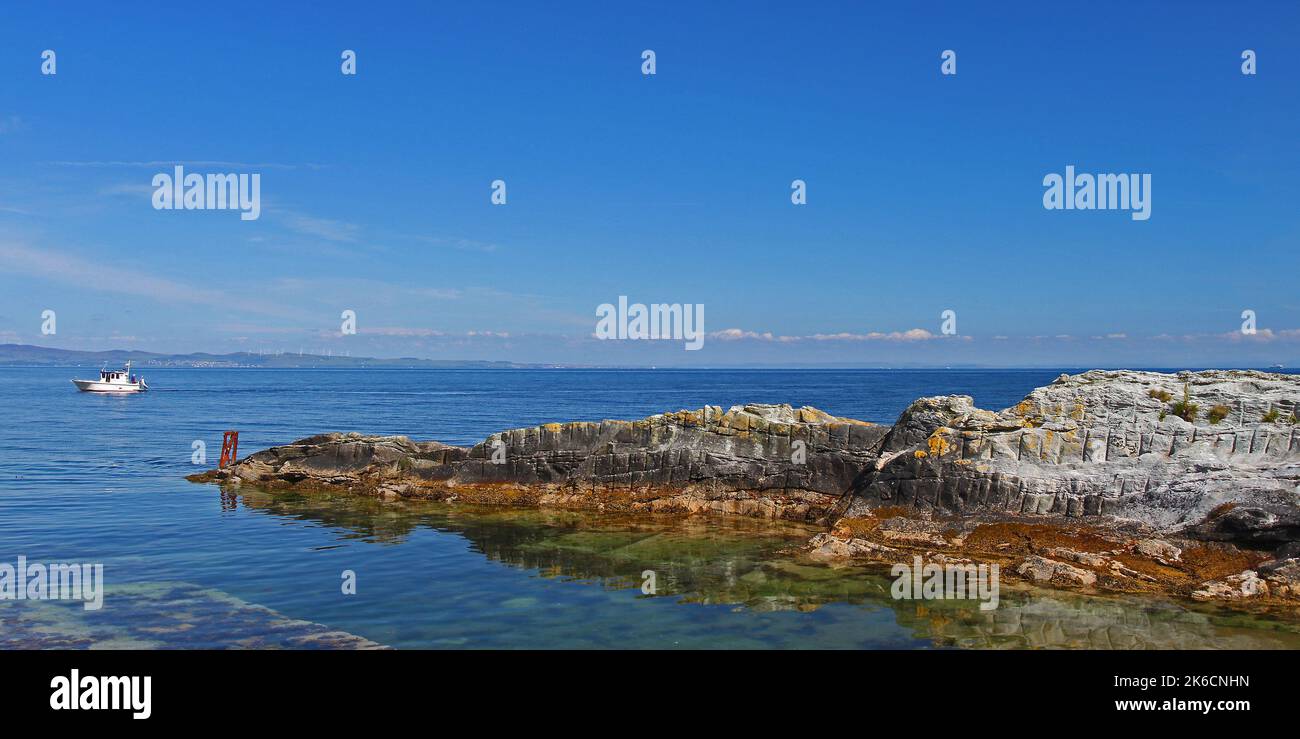 Layered Rocks in Blue Crystal Clear Sea, Sannox, Arran, Isle of Arran, Bute, Buteshire, Scotland, United Kingdom, Great Britain Stock Photo