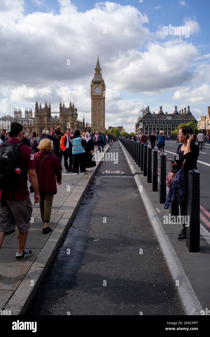 Cycle lane leading to Westminster and Parliament from Westminster Bridge with members of the public walking in road as bridge is closed to traffic. Stock Photo