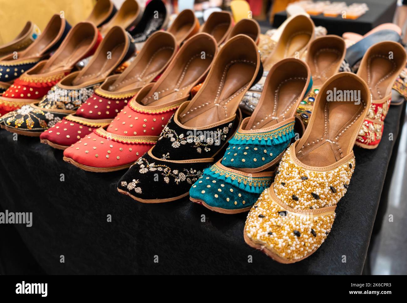Various types of Indian jutti footwear selling in the shopping mall. Stock Photo