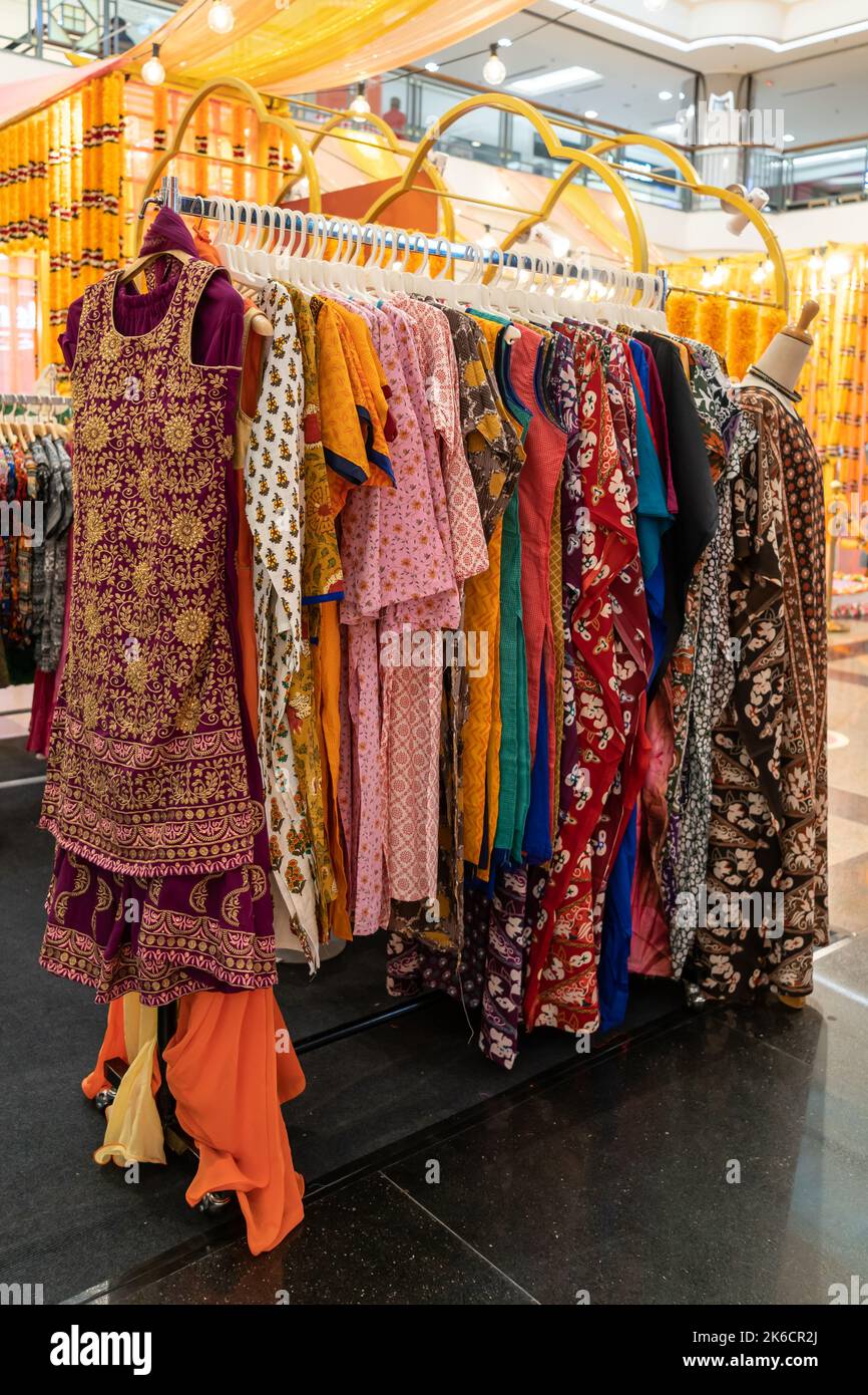 Various types of Indian fashion clothes displaying and selling in the shopping mall. Stock Photo