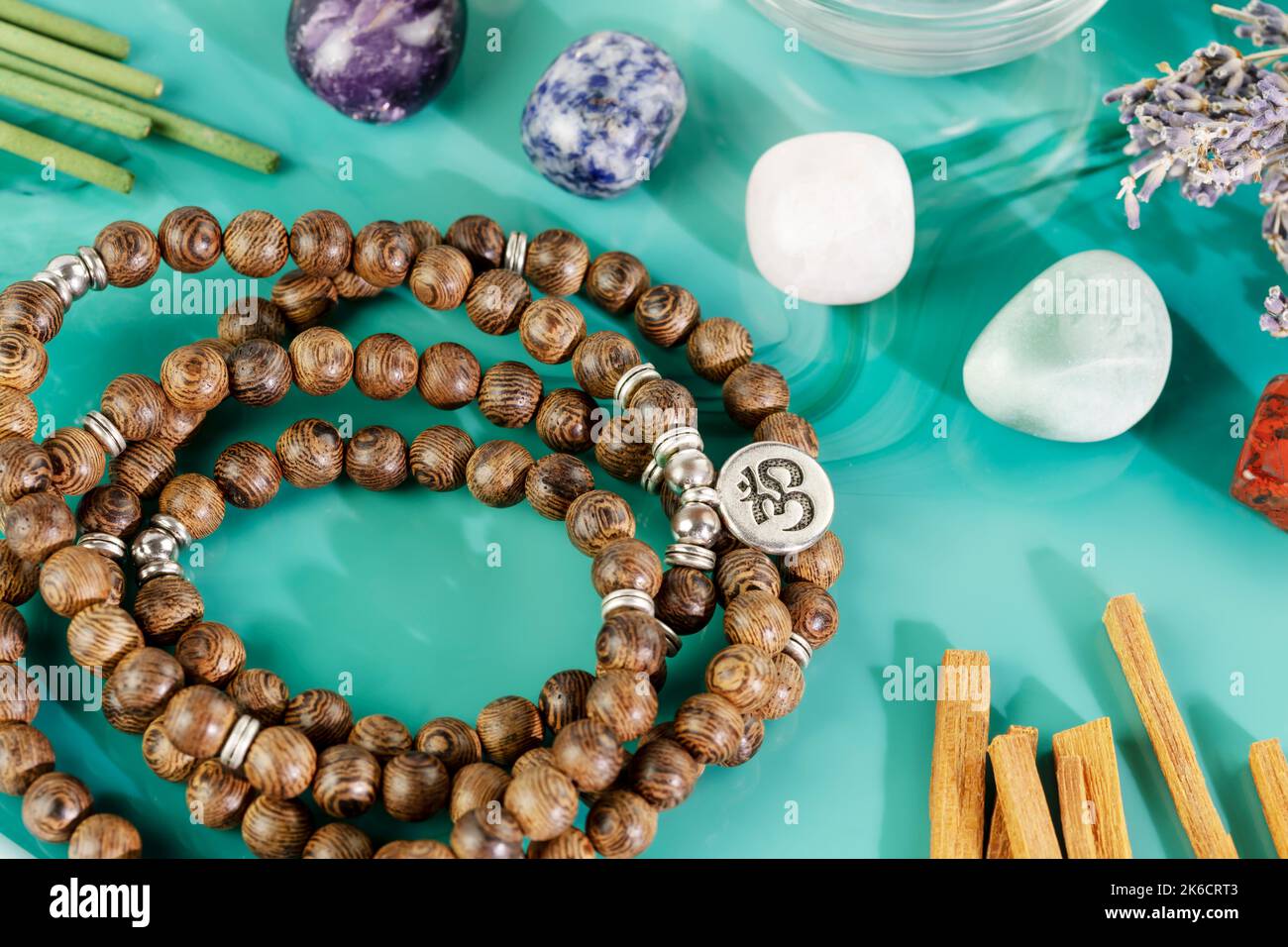 Rosary beads, aroma sticks, chakra stones and sandalwood sticks Stock Photo