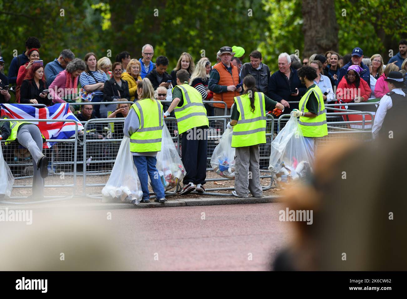 Litter pickers on the Mall collecting waste from the crowd queuing to