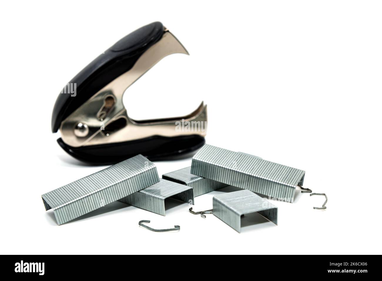 Stapler and anti-stapler with staples on a white background. Office ...