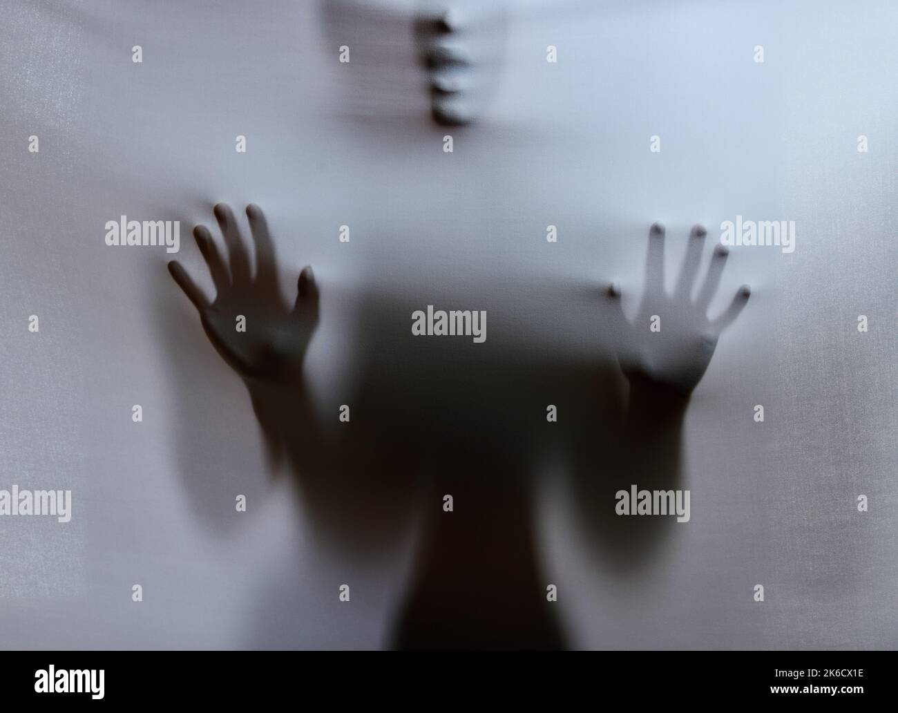 They hide behind my door. a scary figure confined under a sheet. Stock Photo