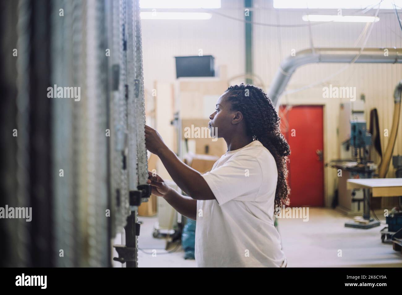 Female carpenter working in workshop Stock Photo
