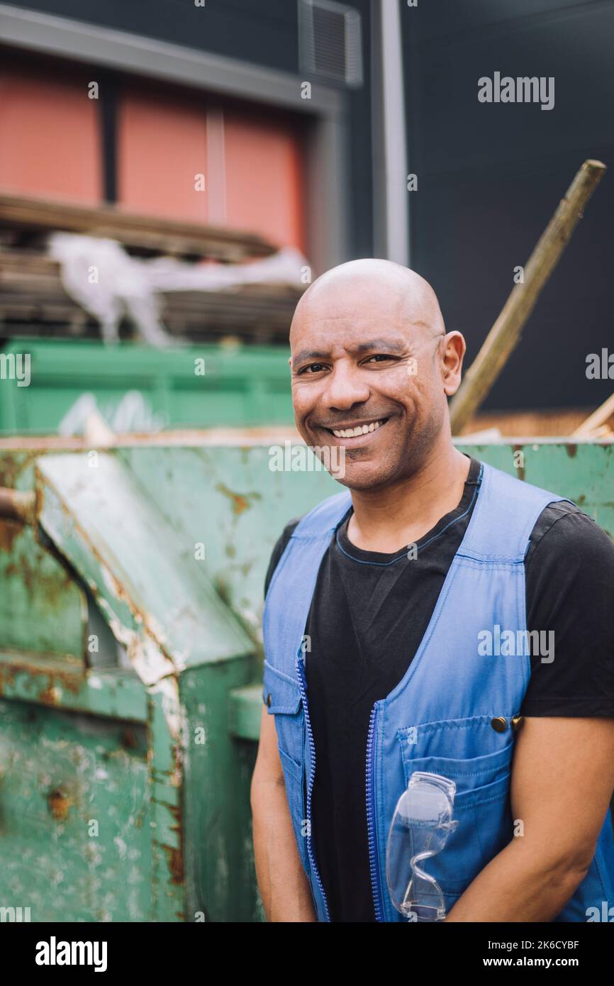 Happy bald mature construction worker at site Stock Photo