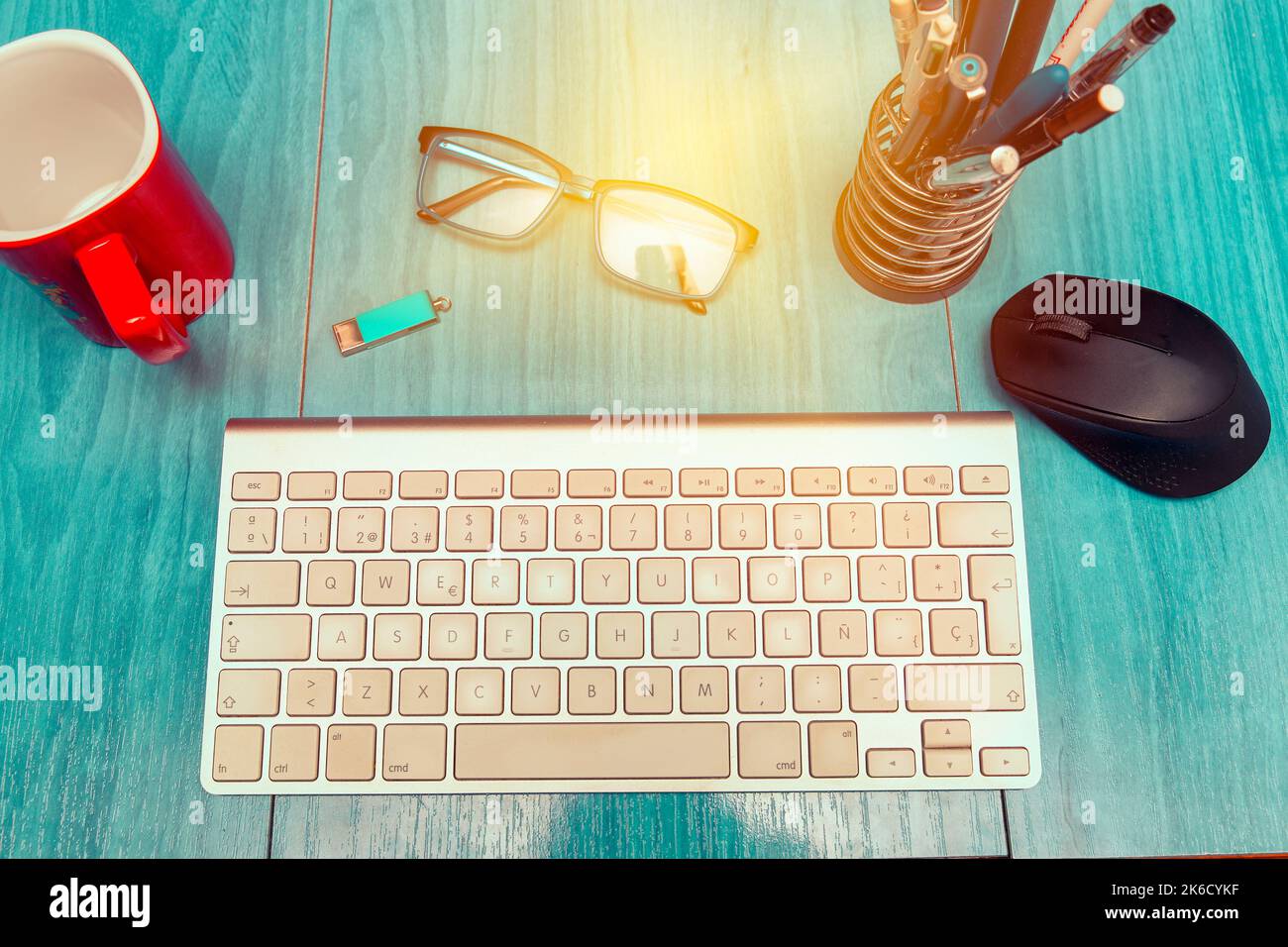 concept of teleworking from home with desktop with a keyboard, mouse and and other work tools Stock Photo