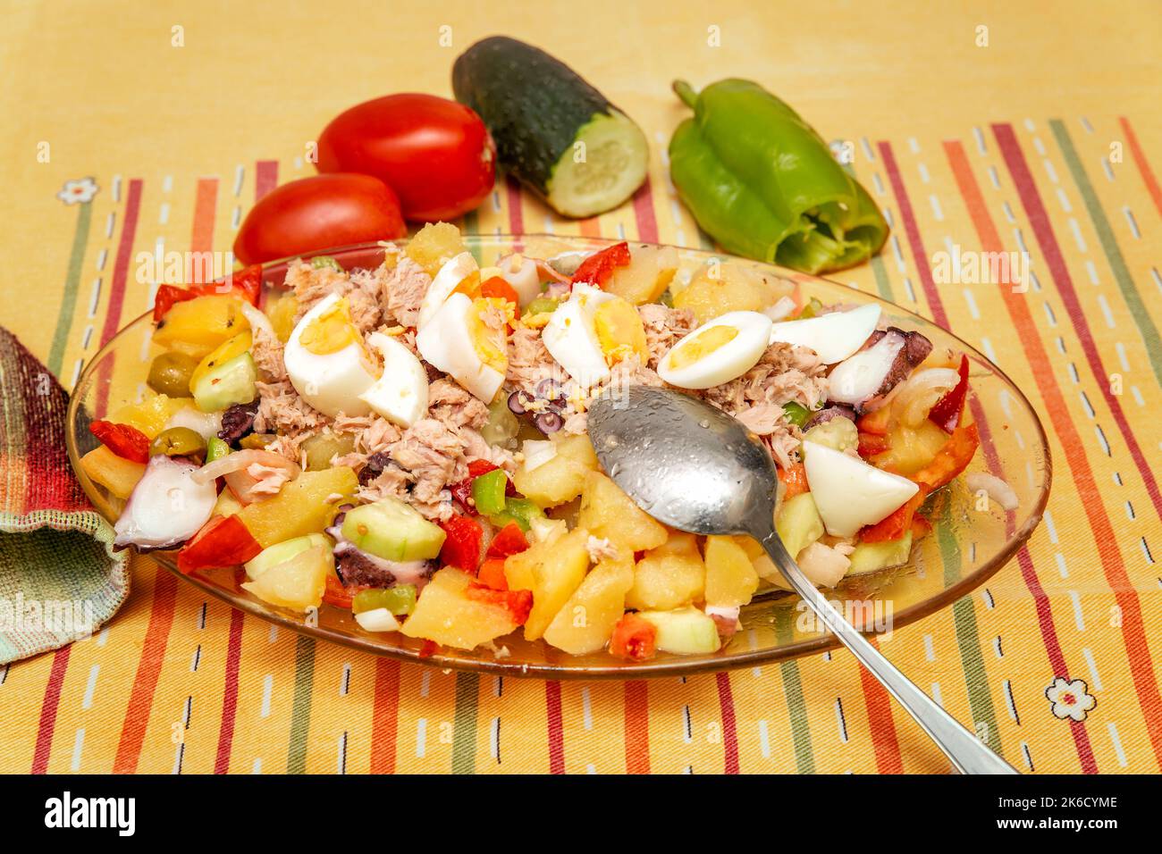 fresh summer salad with potato, tuna, octopus, egg and vegetables