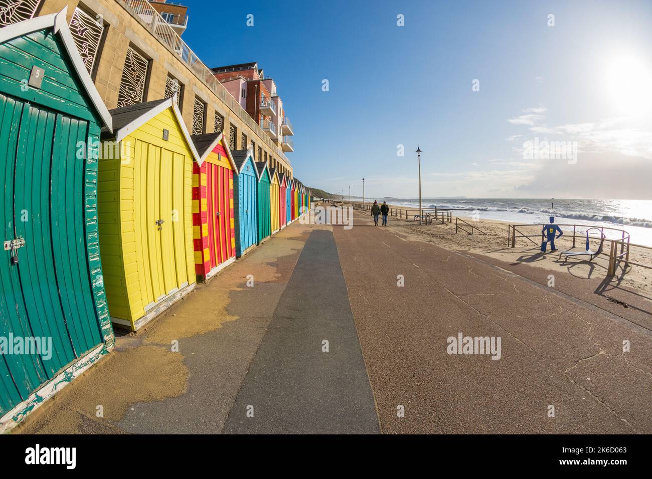 seafront and promenade with beach huts and beach in February