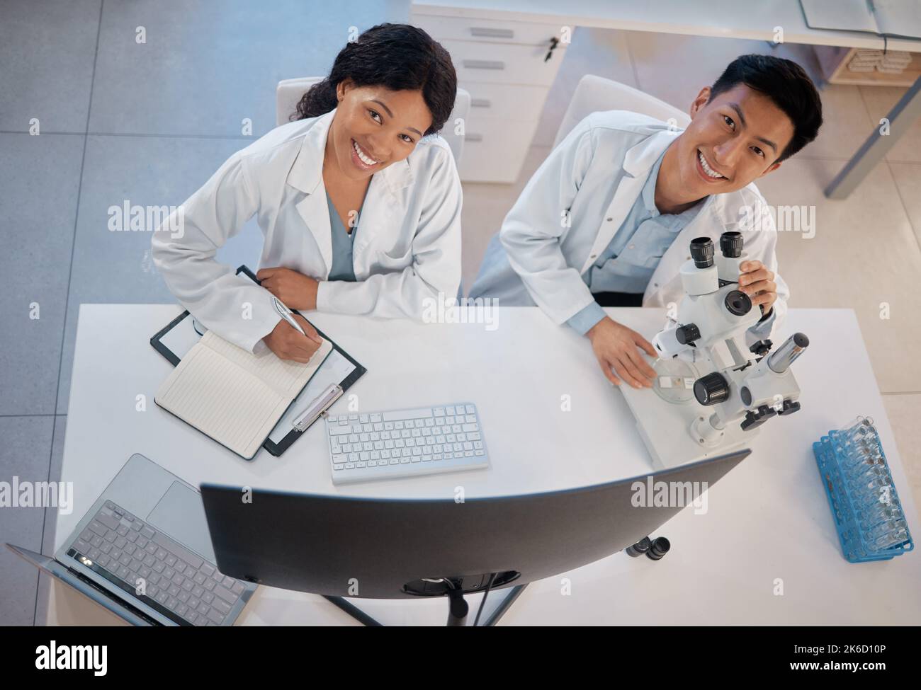 Working to make each other better. two lab workers together in their office. Stock Photo