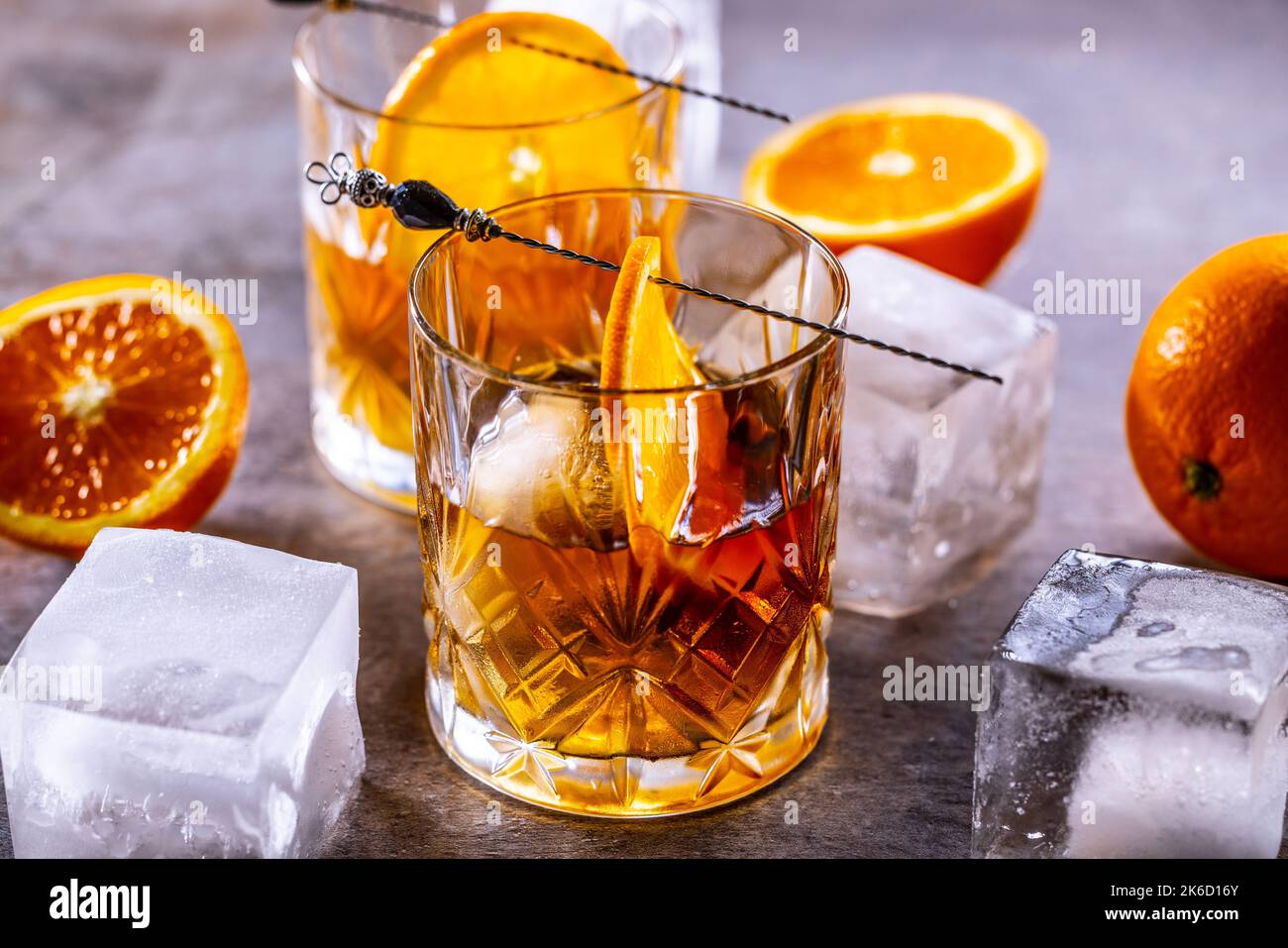 Glasses of cocktail drinks Old fashioned with oranges and ice cubes