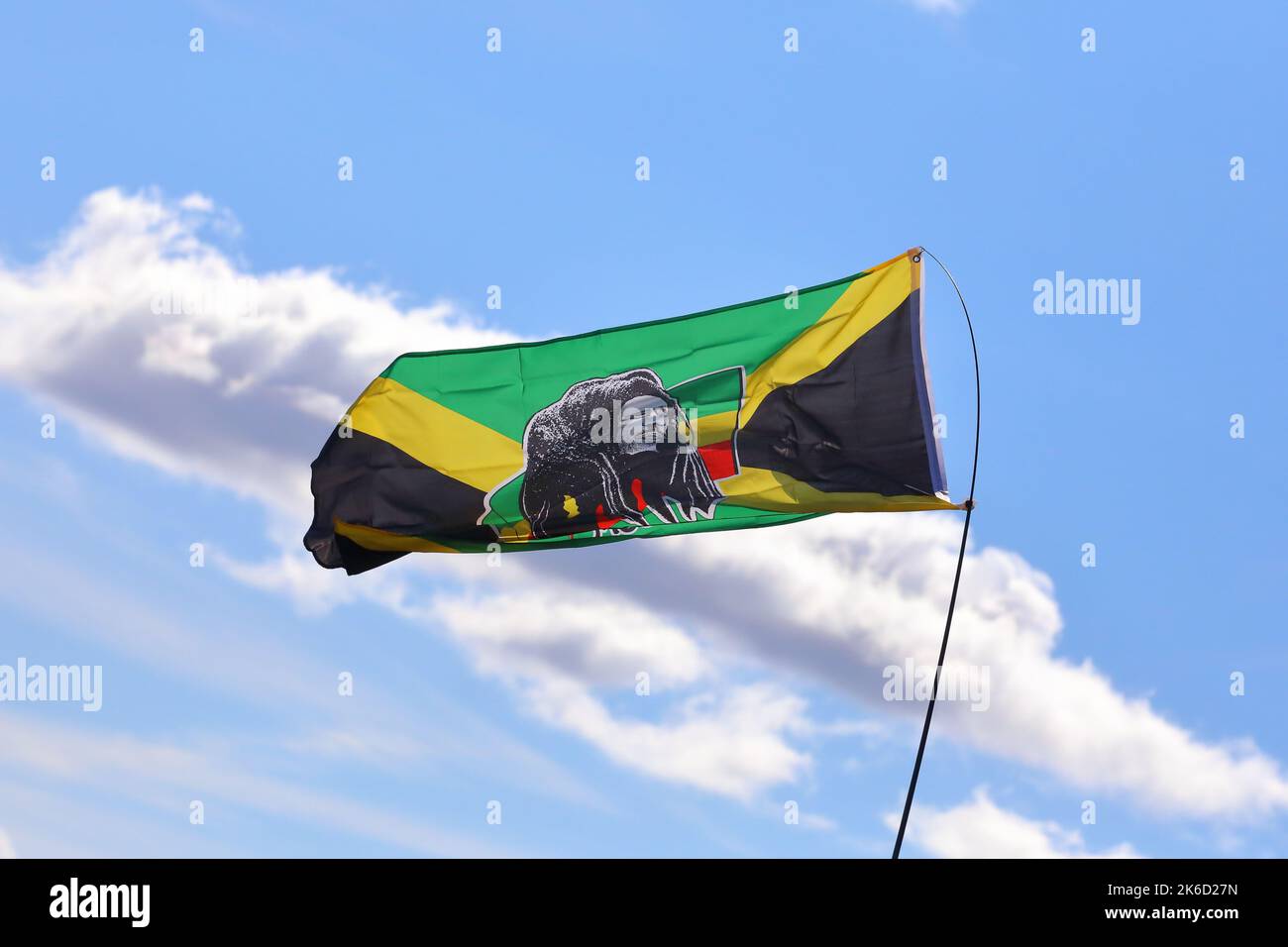 a Jamaican flag with an image of bob Marley flying at wentworth