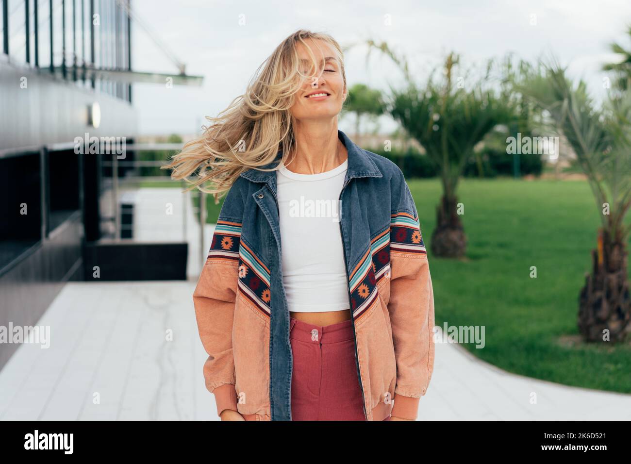 Wind in the hair. Lifestyle portrait of a cheerful caucasian woman with long blond hair. Stock Photo