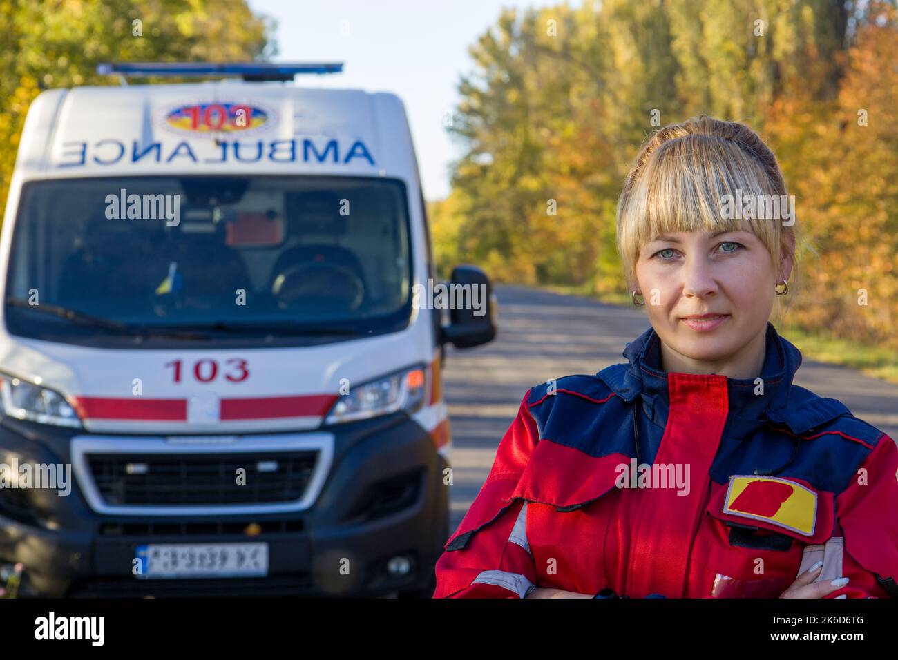 Kyiv. Ukraine. 10.10.2022 A paramedic girl near an ambulance. Selective focus. Stock Photo