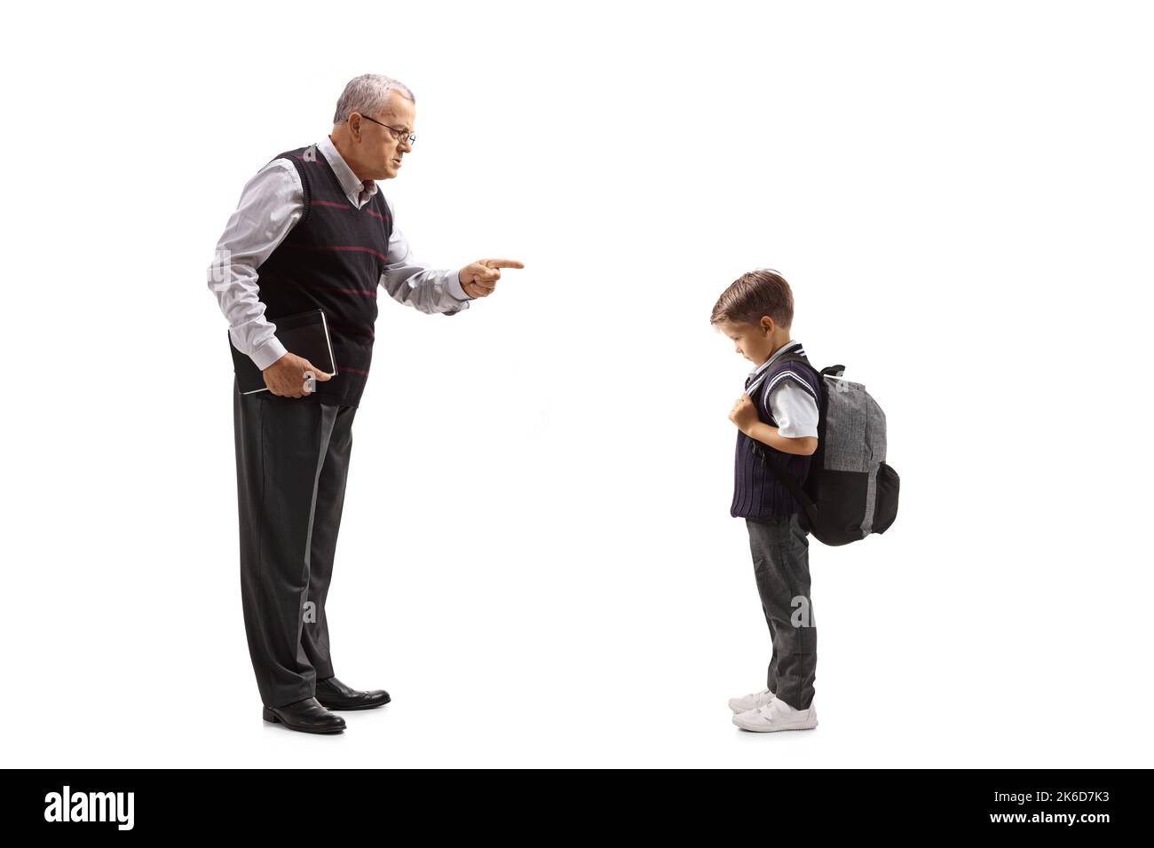 Full length profile shot of a teacher scolding a schoolboy isolated on white background Stock Photo