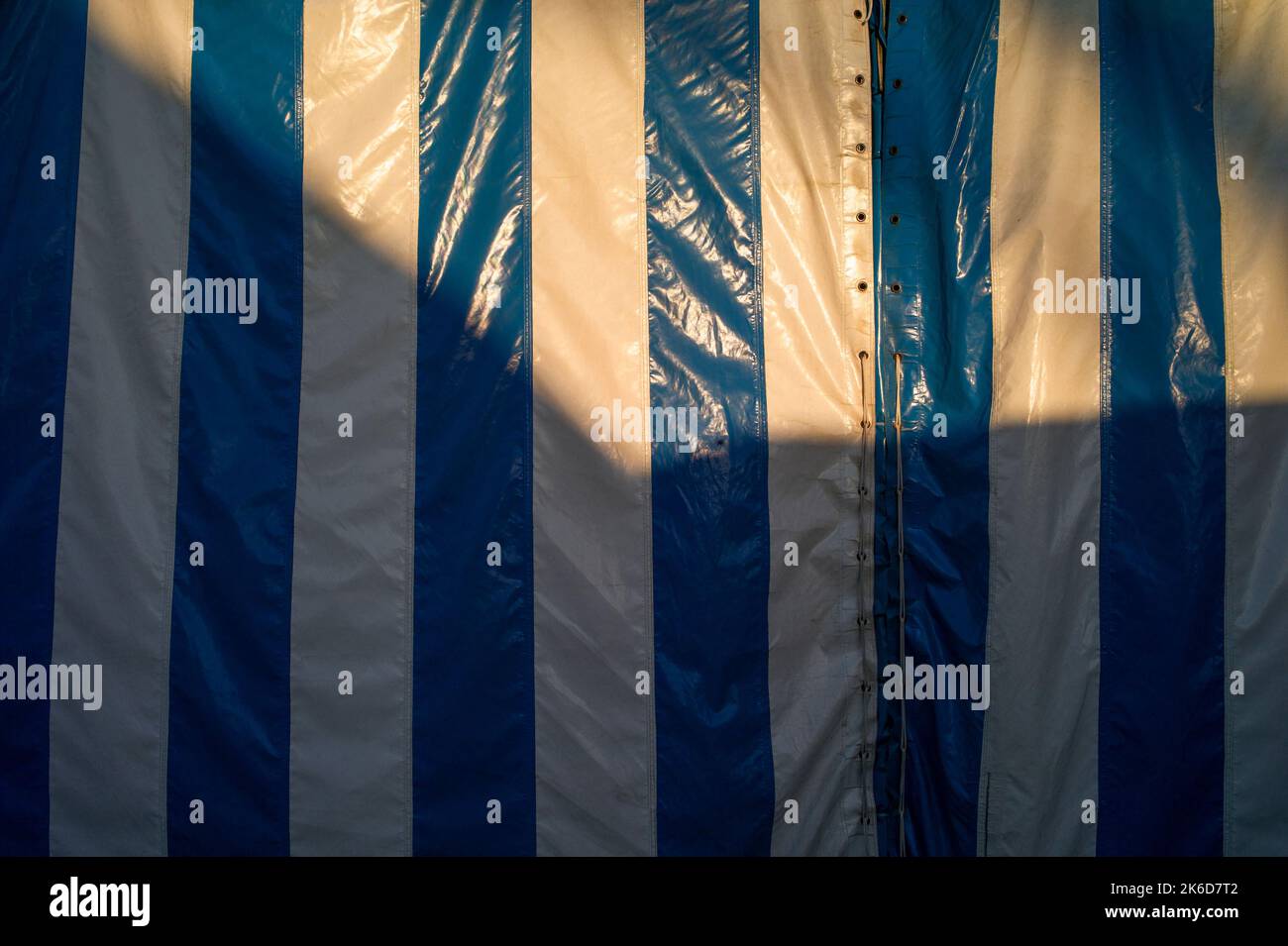 sunlight and shadow on a striped marquee or tent Stock Photo