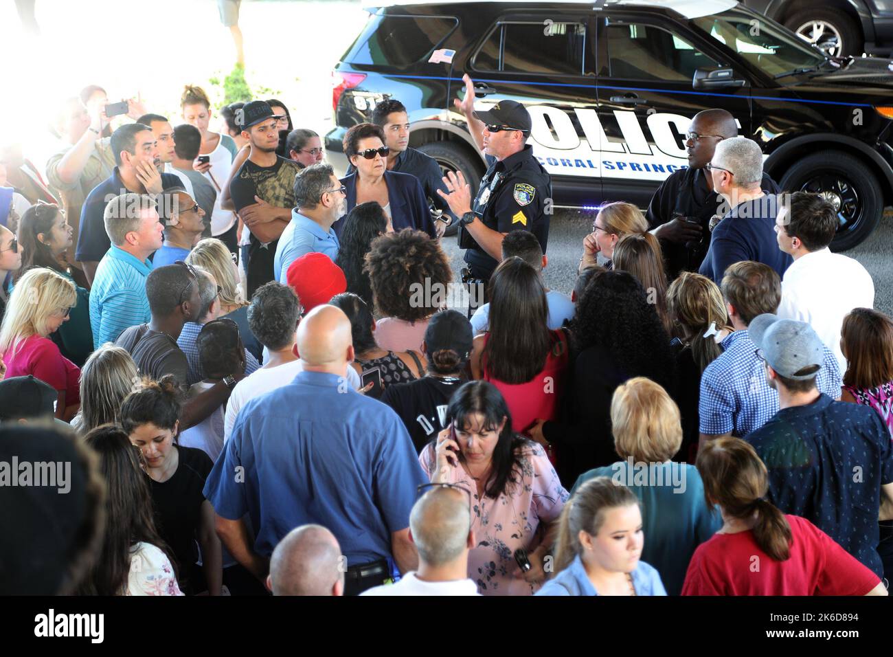 Parkland, USA. 14th Feb, 2018. An officer tells parents waiting at Coral Springs Drive and the Sawgrass Expressway to go to the Marriott hotel to meet up with their kids from Stoneman Douglas High School in Parkland, Fla., after a shooting on Wednesday, Feb. 14, 2018. (Photo by Amy Beth Bennett/Sun Sentinel/TNS/Sipa USA) Credit: Sipa USA/Alamy Live News Stock Photo