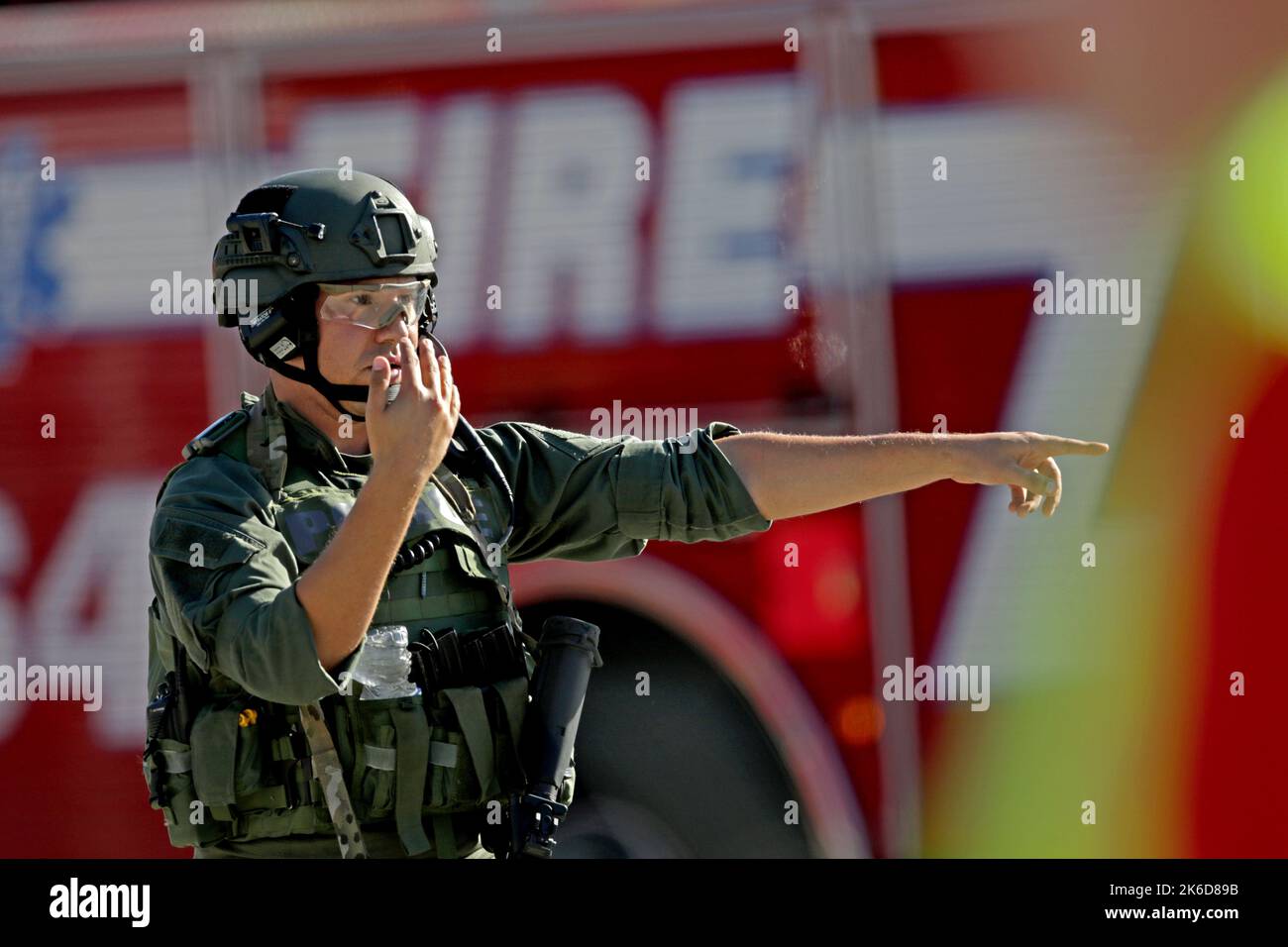 Parkland, USA. 14th Feb, 2018. A law enforcement officer directs traffic outside of Stoneman Douglas High School in Parkland, Fla., after a shooting at the school on February 14, 2018. (Photo by John McCall/Sun Sentinel/TNS/Sipa USA) Credit: Sipa USA/Alamy Live News Stock Photo