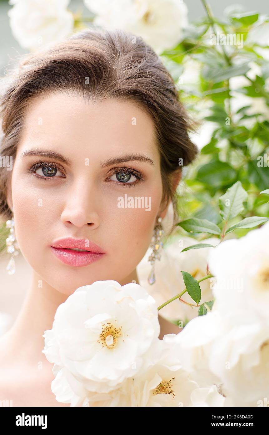 Close up bridal portrait amongst white roses Stock Photo