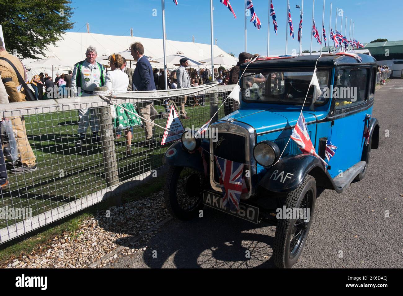 Blue Austin 7 decorated with Union Jack flags to celebrate the centenary of the car's launch in 1922, parked in the paddock, Revival Meeting, Goodwood Stock Photo