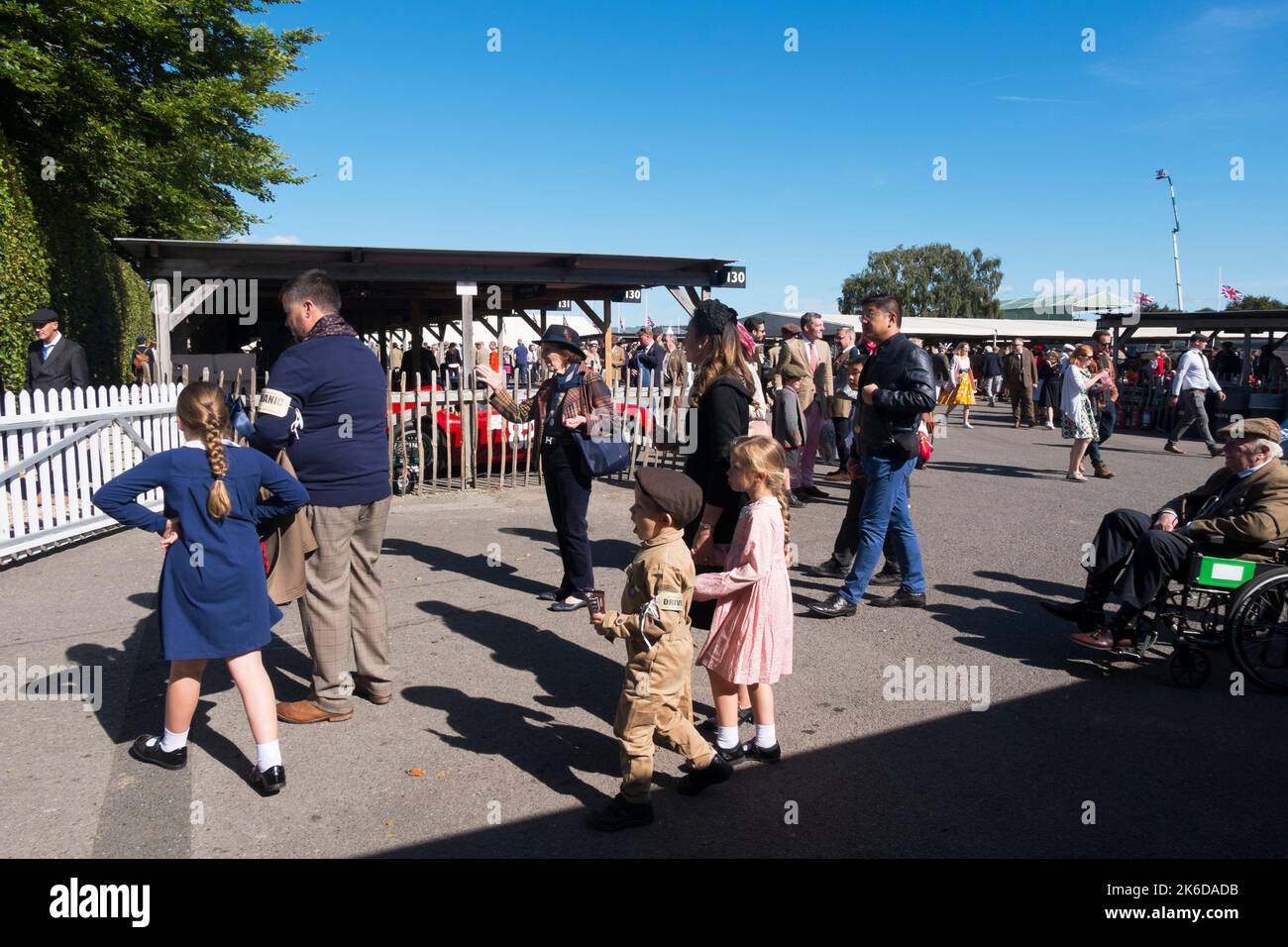 Families in period dress in the paddock at the BARC Revival Meeting at the Goodwood motor racing circuit Chichester, West Sussex, UK,September 2022 Stock Photo