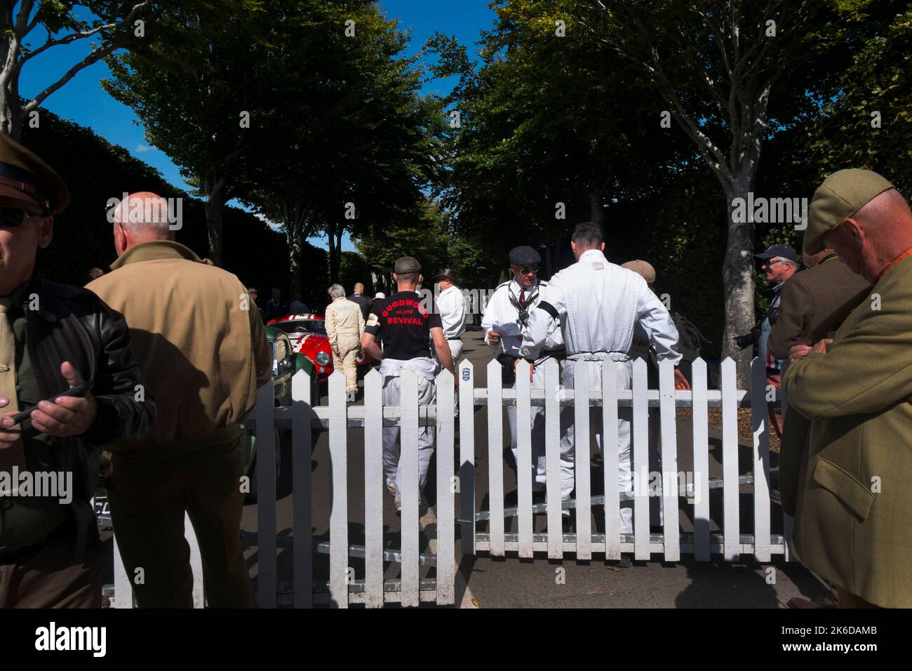 A mechanic with a Revival tshirt on walking into the avenue where cars