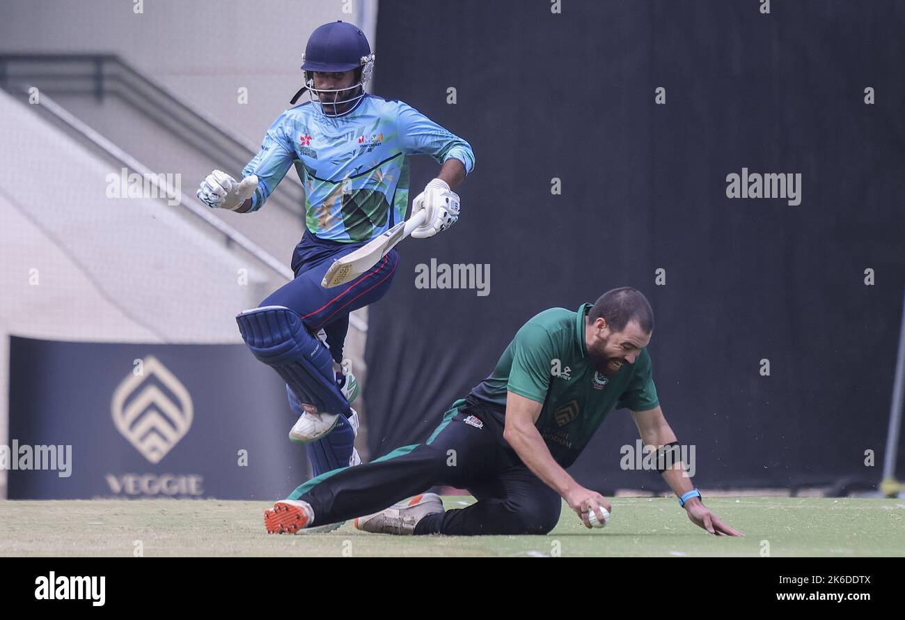 MenHH T20 cricket match between USRC (light blue) and KCC (green), at Kowloon Cricket Club. In action is KCC bowler Jason Davidson and USRC batsman Imran Arif. 09OCT22 SCMP / Jonathan Wong Stock Photo