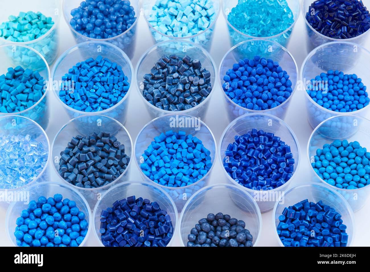 different blue plastic resin granulates for injection moulding process in different granulate types Stock Photo