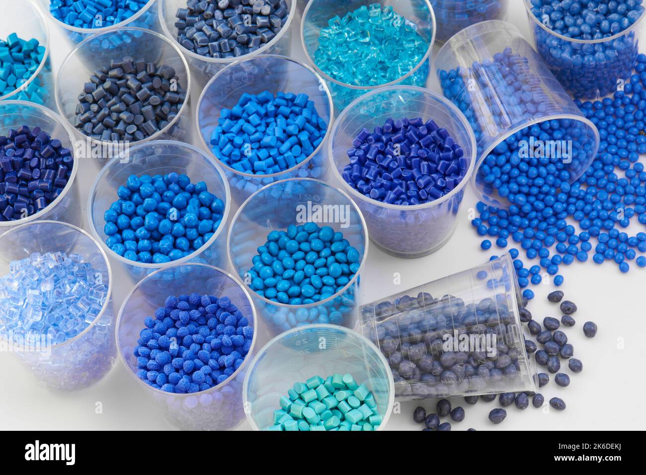 different blue plastic resin granulates for injection moulding process in different granulate types Stock Photo