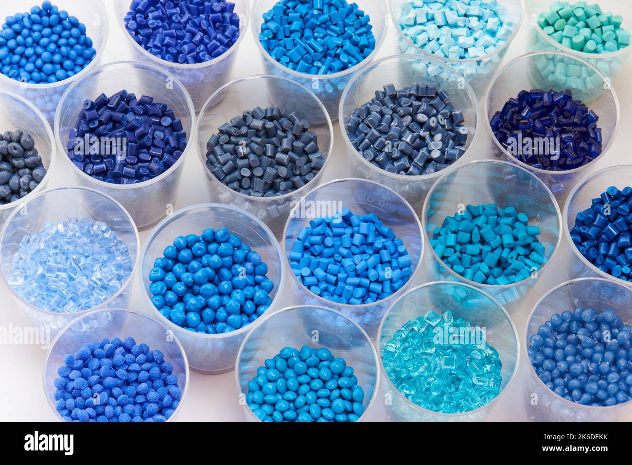 different blue plastic resin granulates for injection moulding process in different granulate types Stock Photo