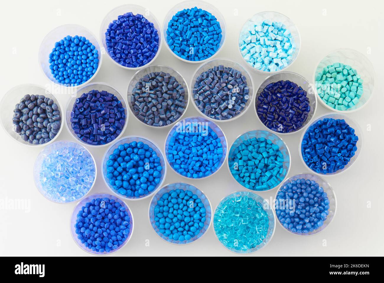 different blue plastic resin granulates for injection moulding process in different granulate types Stock Photo