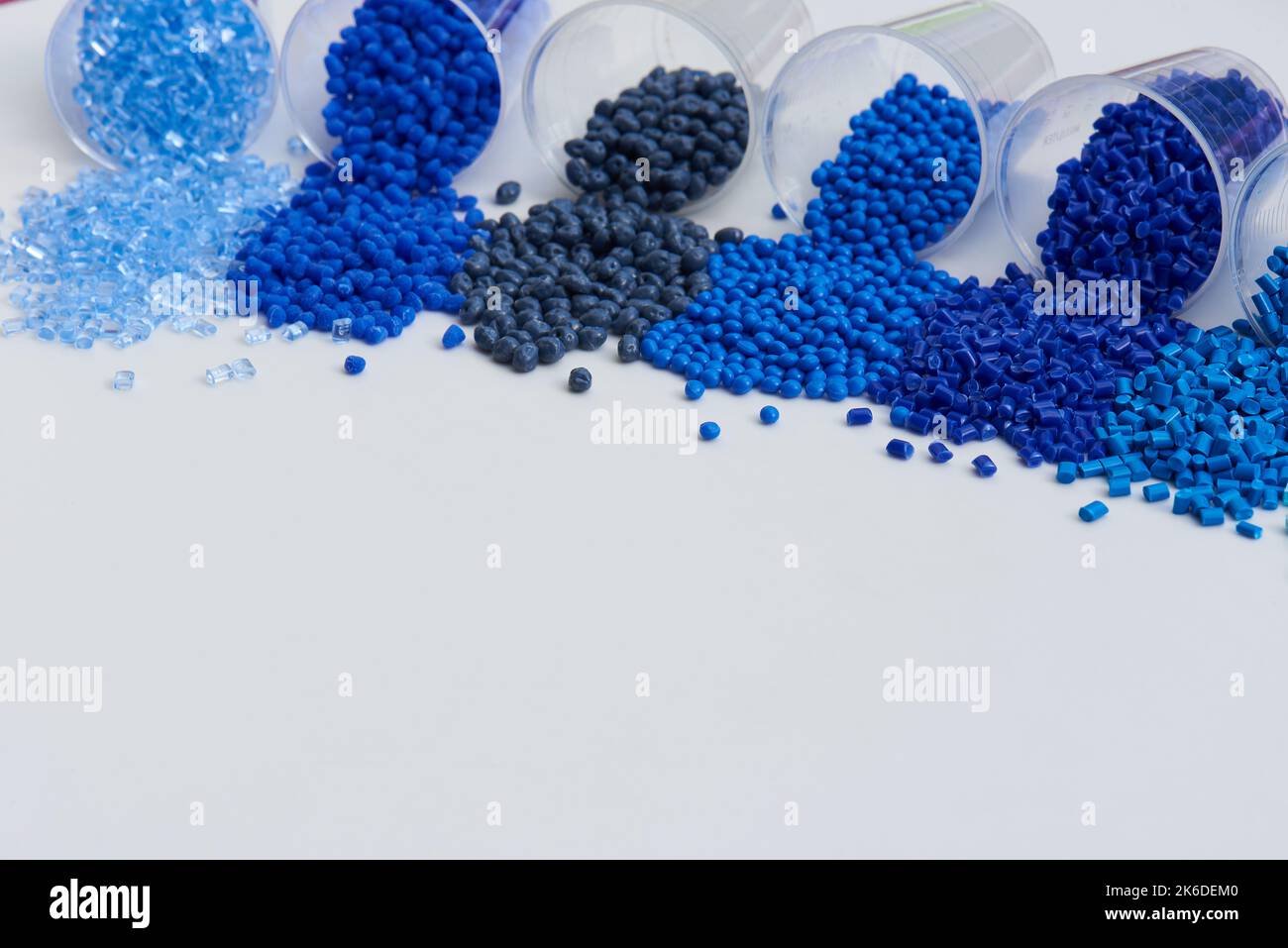 different blue plastic resin granulates for injection moulding process in different granulate types Stock Photo