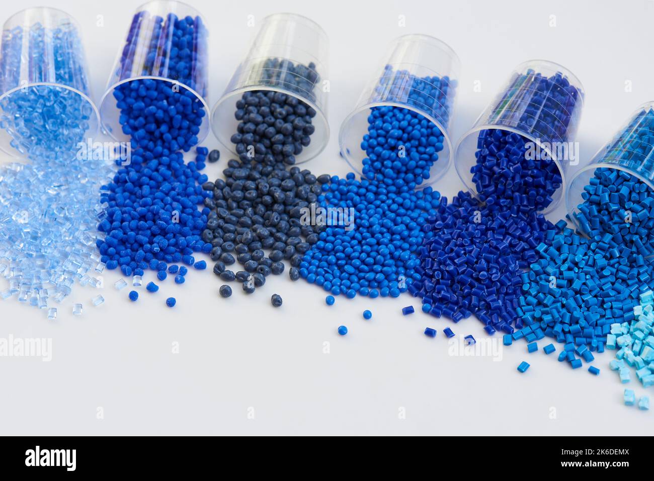 different blue plastic resin granulates for injection moulding process in different granulate types Stock Photo