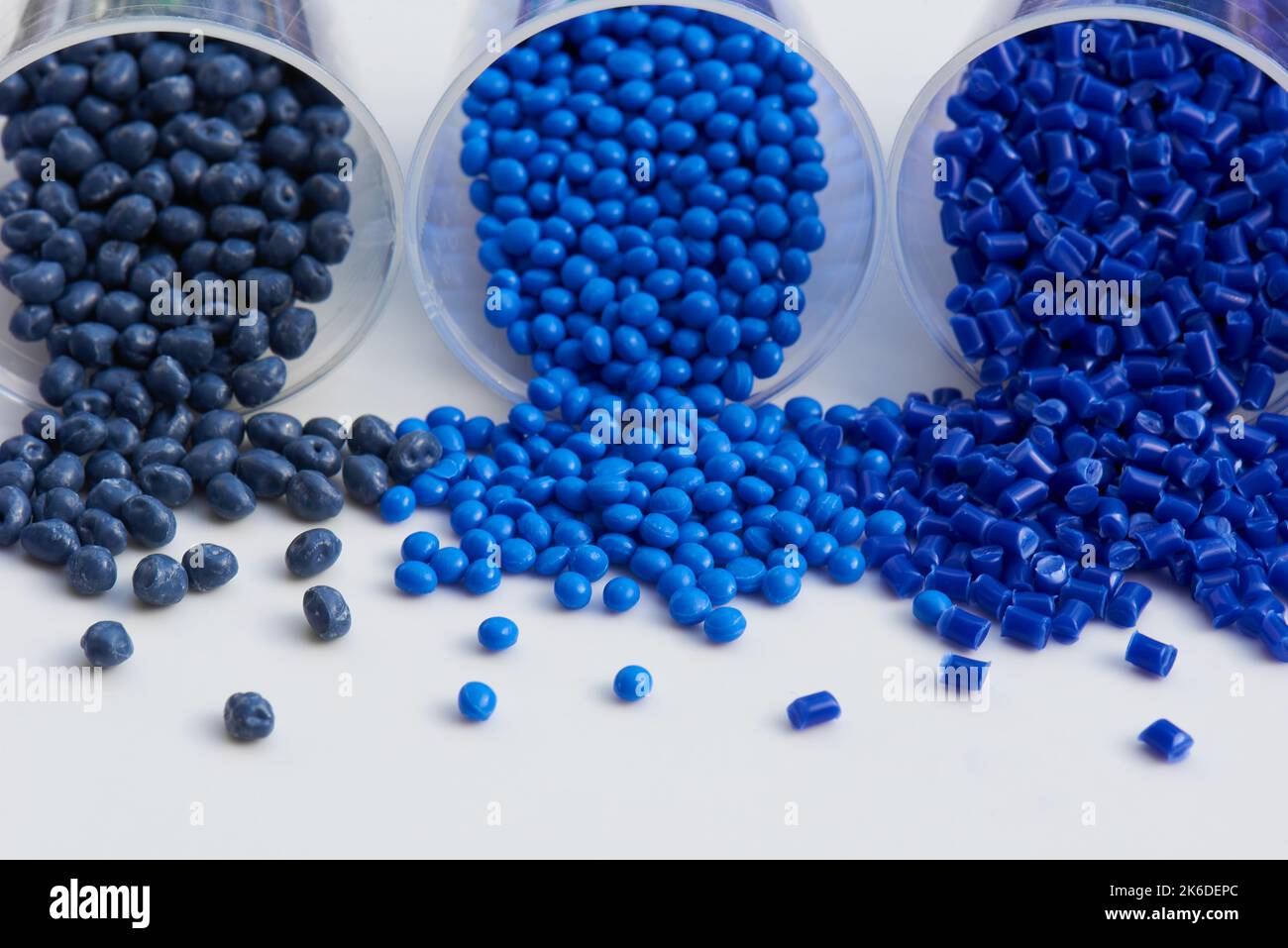 different blue plastic resin granulates for injection moulding process in different granulate types Stock Photo