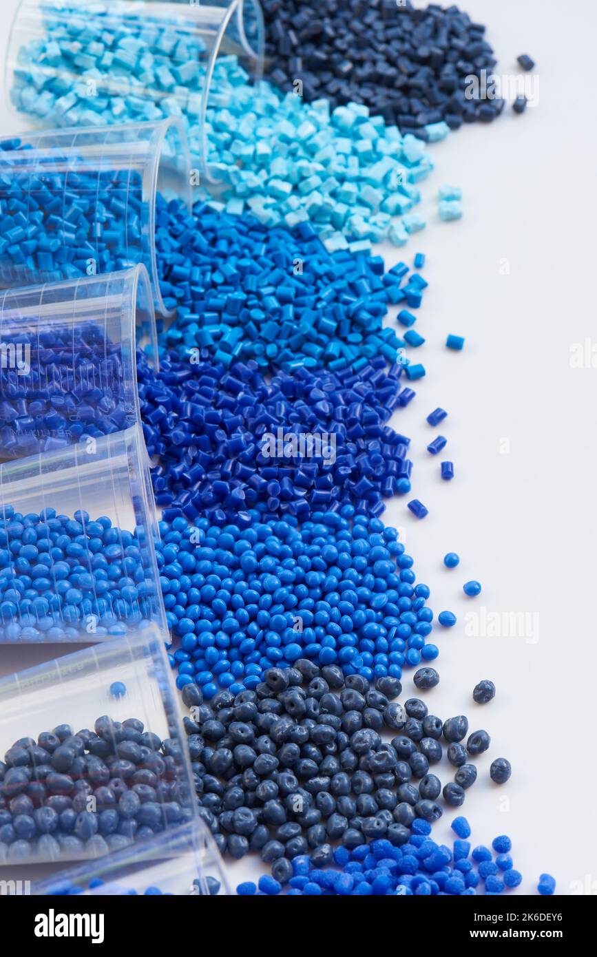 different blue plastic resin granulates for injection moulding process in different granulate types Stock Photo