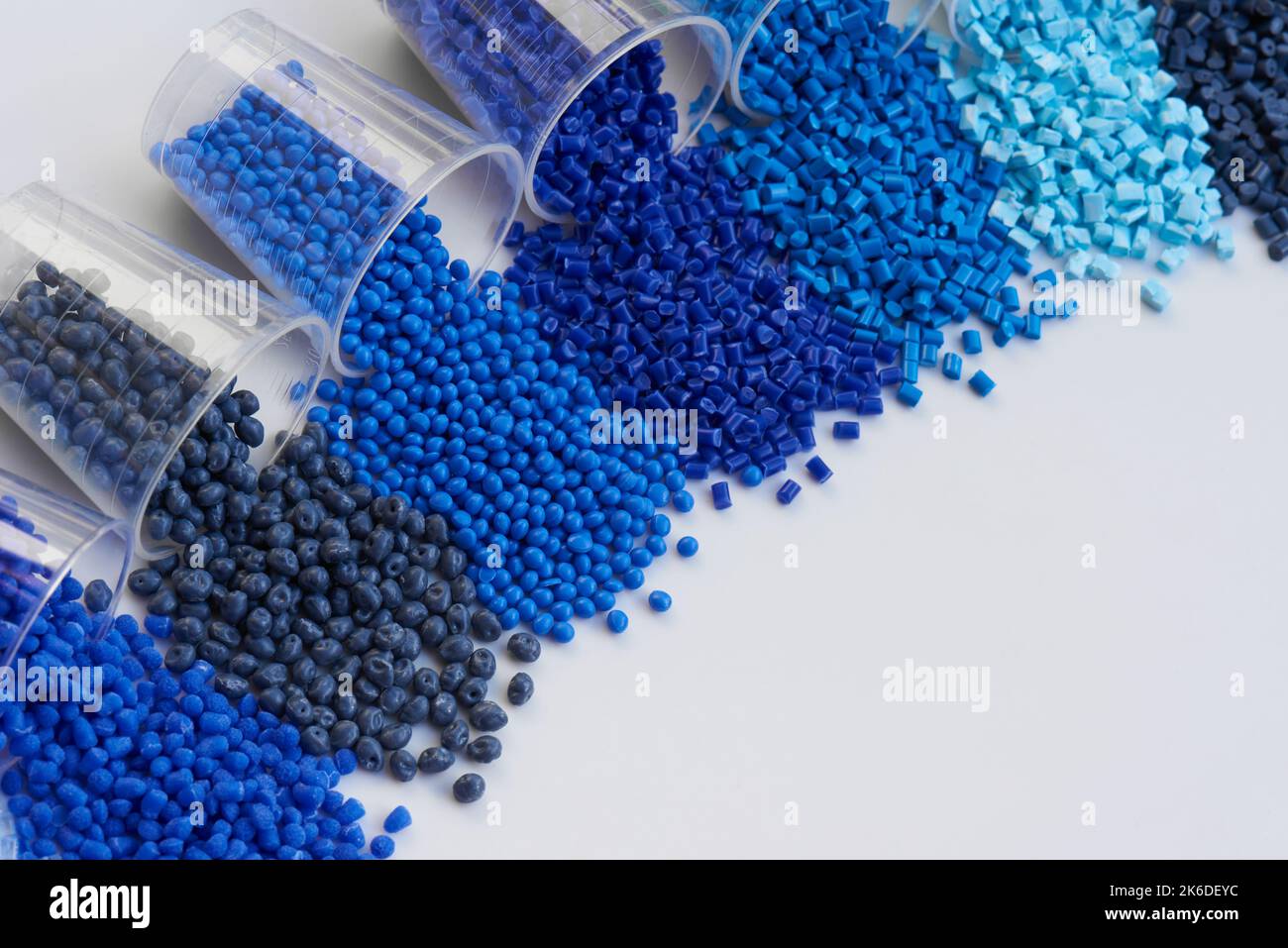 different blue plastic resin granulates for injection moulding process in different granulate types Stock Photo